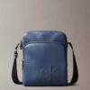 Bolso tipo reporter con bolsillo con cremallera y Monogram en relieve Bolso tipo reporter con bolsillo con cremallera y Monogram en relieve