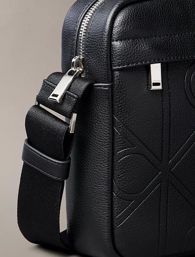 Bolso tipo reporter con logotipo en relieve por toda la superficie Bolso tipo reporter con logotipo en relieve por toda la superficie