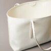 Bolso tote con el logotipo del emblema en toda la superficie y bolsillo Bolso tote con el logotipo del emblema en toda la superficie y bolsillo